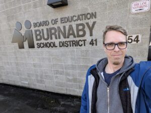 Rand-Hendriksen dropping off book at Burnaby's School District 41
