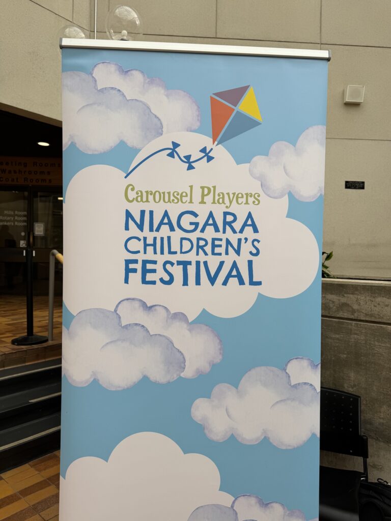 A sign says Carousel Players Niagara Children's Festival